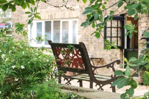 a bench sitting in front of a building at Lee Valley Lodge in Cheshunt