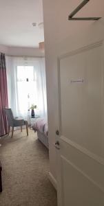 a bedroom with a door and a bed and a window at Conlyn house in Newcastle