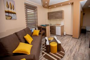 a living room with a couch and a kitchen at Vila Todorović in Bela Crkva
