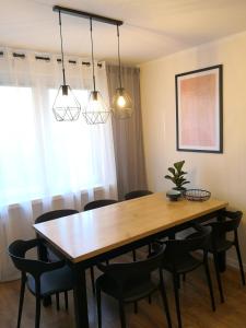 a dining room with a wooden table and chairs at Apartament przy Starówce in Sandomierz