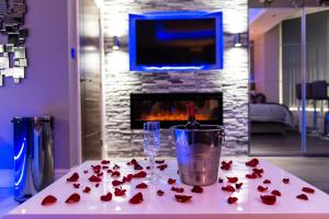 a table with a bunch of roses and a wine glass at Velmora Suites Bradford in Bradford