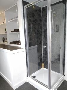 a shower with a glass door in a bathroom at The Old Endie Hoose Kirkwall Orkney in Kirkwall