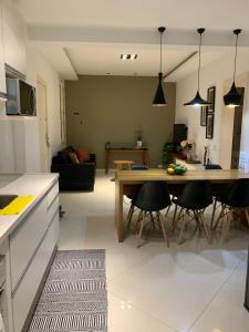 a kitchen and living room with a table and chairs at Charming Apartment in the best area of Ipanema in Rio de Janeiro