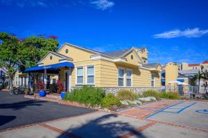 a yellow house with a blue awning at Coronado Inn in San Diego