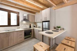 a kitchen with wooden cabinets and a counter top at Niochori apartments 1 in Rhodes Town