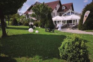 a yard with two white balls on the grass at Hotel Empfinger Hof, Sure Hotel Collection by Best Western in Empfingen