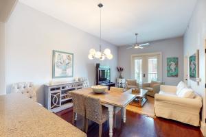 a living room with a table and a couch at Redfish Village Condos in Santa Rosa Beach