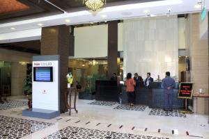a group of people standing in a lobby at Ramada by Wyndham Islamabad in Islamabad