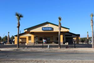 a grocery store with palm trees in front of it at Travelodge by Wyndham Unadilla - Perry Near I-75 in Unadilla