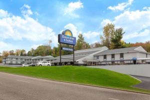 a sign for a dixon inn and suites at Days Inn & Suites by Wyndham Wisconsin Dells in Wisconsin Dells