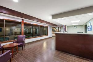 a lobby of a hospital with a bar and chairs at Days Inn & Suites by Wyndham Wisconsin Dells in Wisconsin Dells