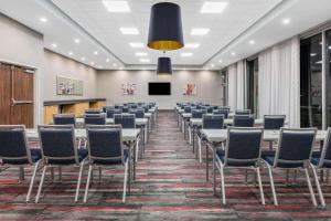 a conference room with tables and chairs and a podium at La Quinta Inn & Suites by Wyndham Lewisville in Lewisville +49 photos