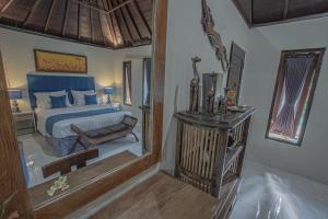 Ein Bett oder Betten in einem Zimmer der Unterkunft Tirta Bali Villa