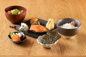 a table with two bowls and a plate of food at Hotel Kazusaya in Tokyo