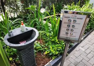 a birdbath with a bird on it next to a sign at MaxOneHotels.com at Sabang in Jakarta