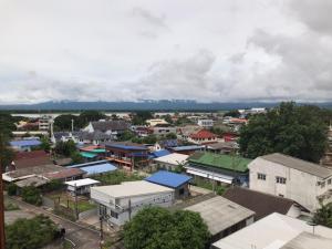 an aerial view of a town with houses and buildings at P Bliss hotel in Phayao +14 photos