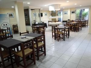 a dining room with tables and chairs in a restaurant at Hotel Aoma Mar del Plata in Mar del Plata +19 photos