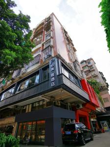 a building with a car parked in front of it at Paco Hotel Beijing Road Metro Guangzhou in Guangzhou