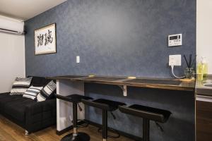 - un bar dans le salon doté d'un canapé dans l'établissement Shiki Homes RURI, à Osaka
