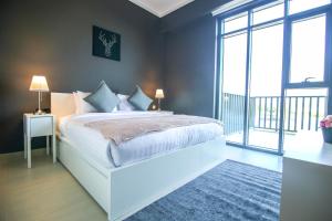 a bedroom with a bed and a large window at Lux BnB Vida Residences The Hills-3BDR+Maids Golf Course View in Dubai