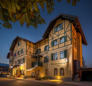 a large white building with a sign on it at Hotel Triglav in Bled