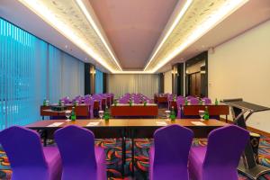a conference room with purple chairs and tables at Fox Hotel Jayapura in Jayapura