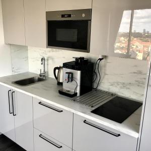 a kitchen with a coffee maker on a counter at City Apartment in Klaipėda
