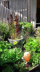 a garden with a planter with flowers and plants at Gasthof Altes Hammerherrenhaus in Übelbach