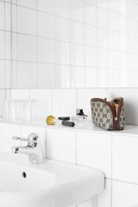 a bathroom with a sink and a purse on a counter at Hasse på Sjökanten Hotell & Restaurang in Jönköping