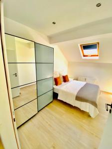 a bedroom with a bed and a sliding glass door at Cozy flat near Moselle Remich in Remich
