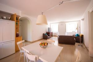 a kitchen and living room with a white table and chairs at Apartment Pupica in Dubrovnik