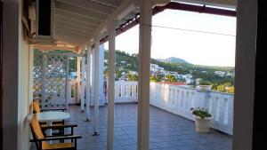 a balcony with a table and a view of a city at Ikos Studios and Apartments in Patitiri