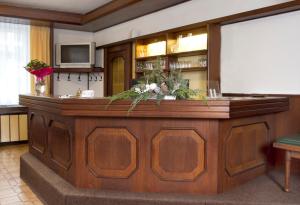 a large wooden bar in a room with a screen at Hotel zur Sonne in Korneuburg