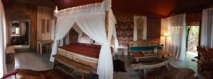 
a large bed with a canopy over it at Sang Giri - Mountain Glamping Camp in Jatiluwih
