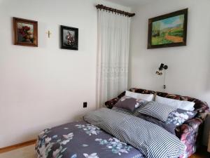 A bed or beds in a room at Júlia Vendégház