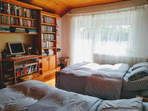 A bed or beds in a room at Júlia Vendégház