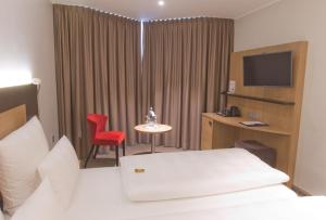 Postel nebo postele na pokoji v ubytování Astor & Aparthotel