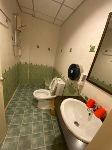 a bathroom with a toilet and a sink at Honey House 2 in Bangkok