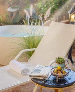 a bowl of fruit on a table on a chair at Villa Brown Moshava - a member of Brown Hotels in Jerusalem +33 photos
