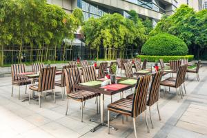 a group of tables and chairs in front of a building at Holiday Inn Xi'an Greenland Century City, an IHG Hotel in Xi'an