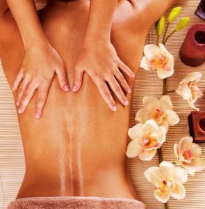 a woman laying on a towel with her legs and flowers at Linfinity in Baillonville