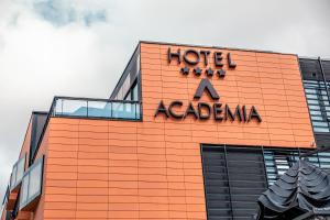 an orange building with a hotel a acacia sign on it at Hotel Academia in Zagreb