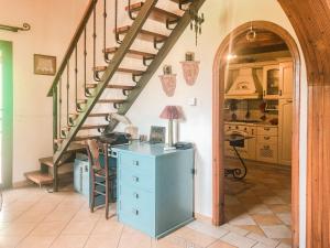 a kitchen with a staircase and a desk in a room at Corfu Christina's House in Potamós