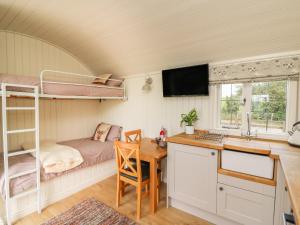 a bedroom with a desk and a bunk bed at Hillside View in Saint Harmon