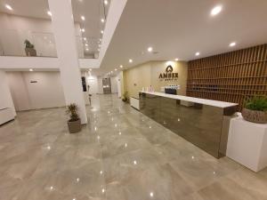 an empty lobby with a counter in a building at Amber Hotel Albania in Spille