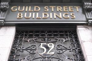 a sign that reads guild street buildings on a building at Bluetree Apartments Guild Street City Center in Aberdeen