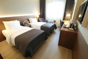 En eller flere senger på et rom på Holiday Inn Bursa - City Centre, an IHG Hotel