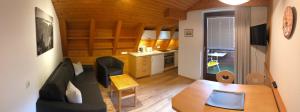 a living room with a table and a kitchen at Landhaus Scherl in Seefeld in Tirol