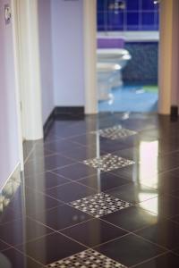 a bathroom with a black tiled floor and a tub at Apartments Vinka in Sveti Filip i Jakov