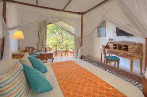 a bedroom with a bed and a desk at Bluebay Beach Resort & Spa in Kiwengwa